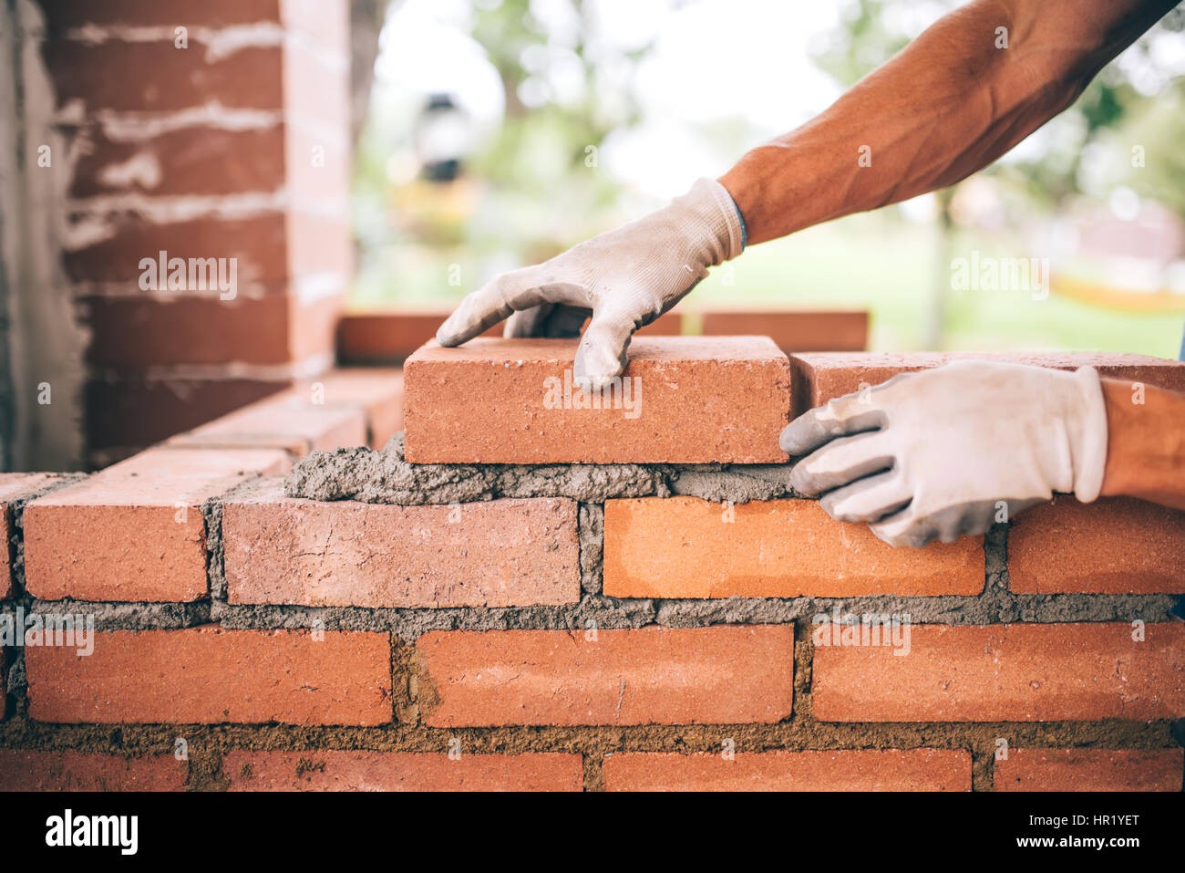 Mason laying bricks professionally